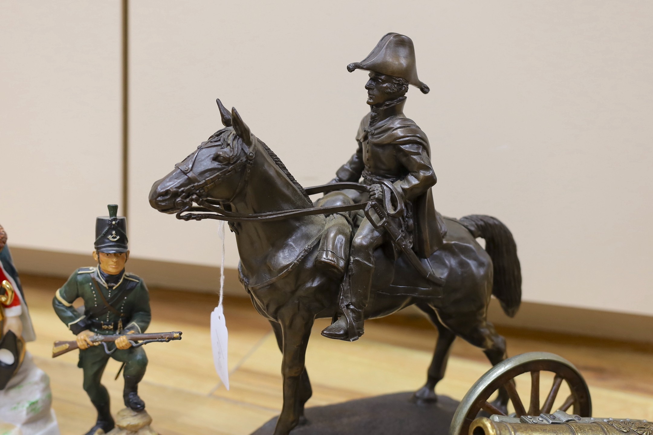 Duke of Wellington and Napoleonic war interest – a group of composition and ceramic figures of soldiers, a model of a cannon, a composition group of Wellington on horseback etc.